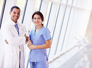 Two doctors smiling at the camera